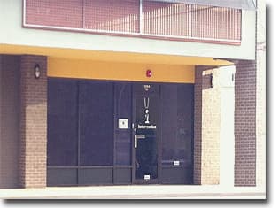 Dark glass office entrance with the Intervention name on the door