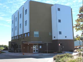The four-story ICCS West building with its glass entrance