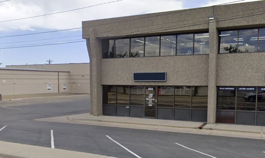 Two-storey office building with ground-floor windows and the number 624 on the door