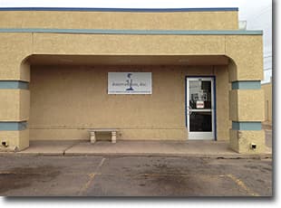 Tan stucco storefront with an Intervention, Inc. sign over the door